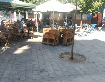 Sillas retiradas por Urbanismo apiladas en el centro de la plaza para su traslado a almacenes municipales