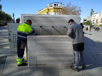 Dos operarios toman muestras del agua de la fuente de los jardines del Cristina 